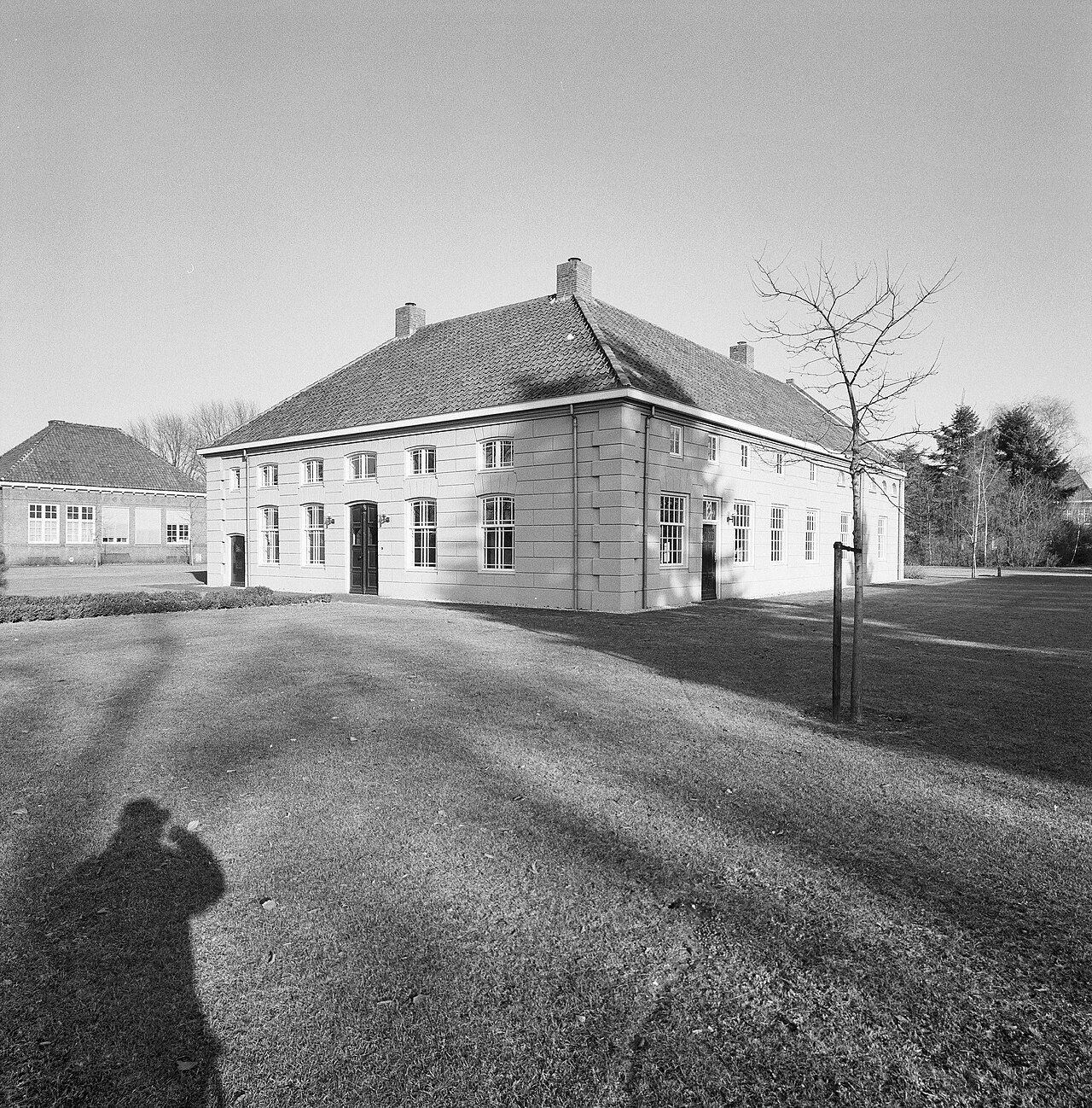 Het lage witte hoofdgebouw van de oude Kluis van Huize Padua